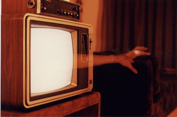 ghostly hand protruding from a TV set